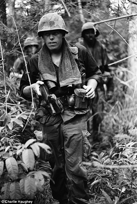 Tough: Soldiers wore towels around their necks to wipe away sweat in the relentless jungle heat